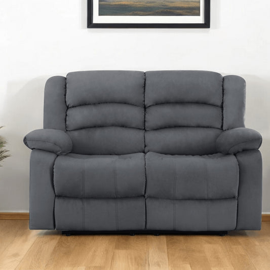Gray sofa in a room with a framed picture on the wall.