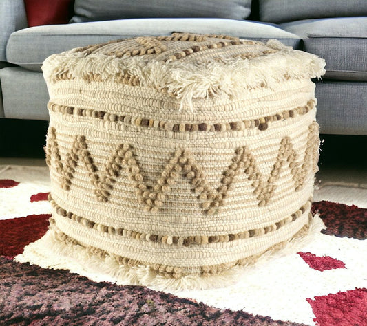 Decorative woven ottoman on a patterned rug with a blurred sofa in the background