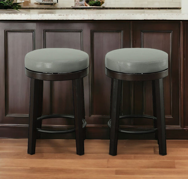 Set of Two 24 Gray And Espresso Faux Leather And Solid Wood Swivel Backless Counter Height Bar Chairs