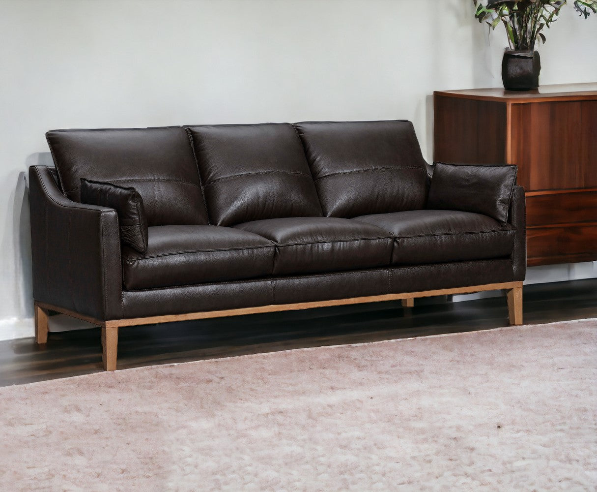 87" Dark Brown Leather Sofa And Toss Pillows With Brown Legs